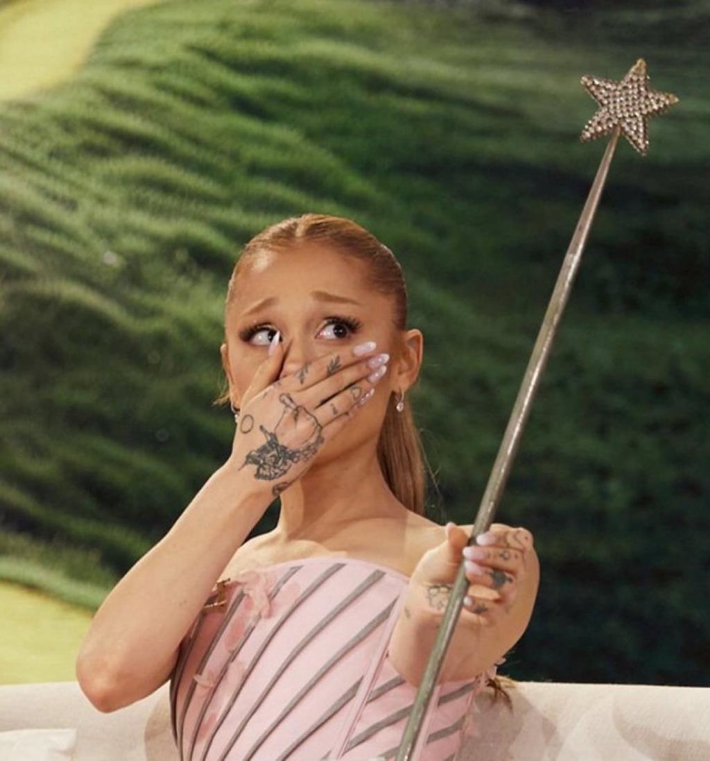 Ariana Grande holding Glinda’s original wand from .jpg