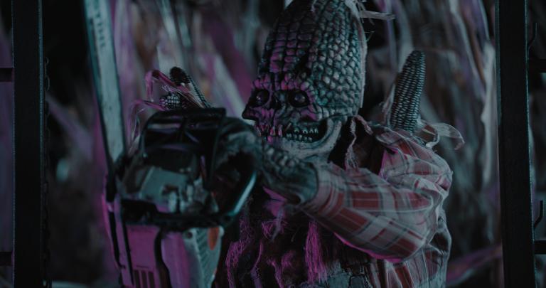Candycorn-Scarecrow-with-chainsaw.webp.jpg