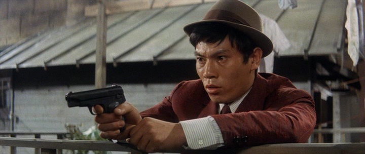 youth-of-the-beast-1963-001-medium-shot-man-with-revolver-and-hat.jpg